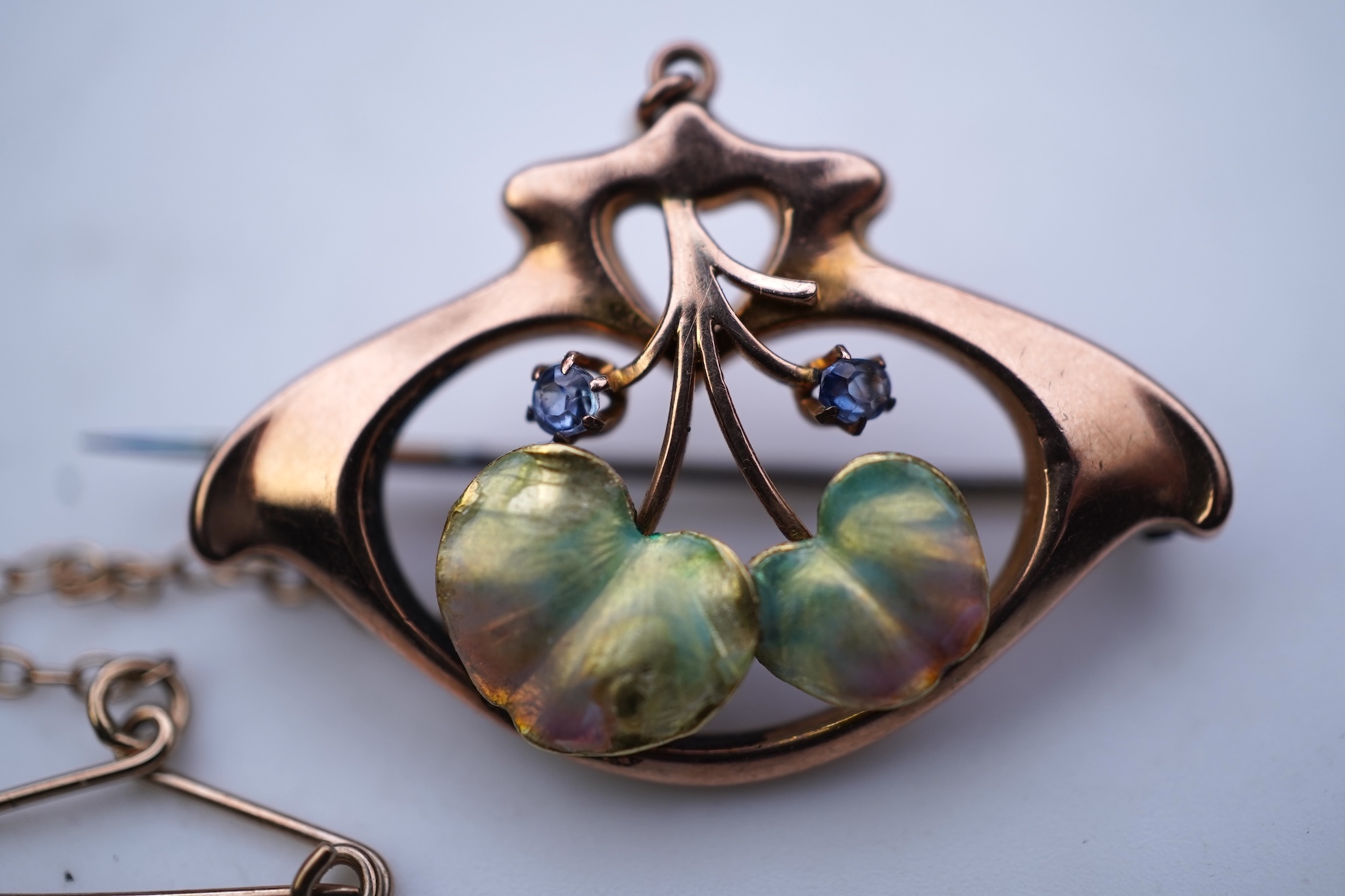 An attractive Art Nouveau enamel, sapphire and seed pearl brooch, early 20th century
